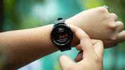 a close up of a person holding a smart watch